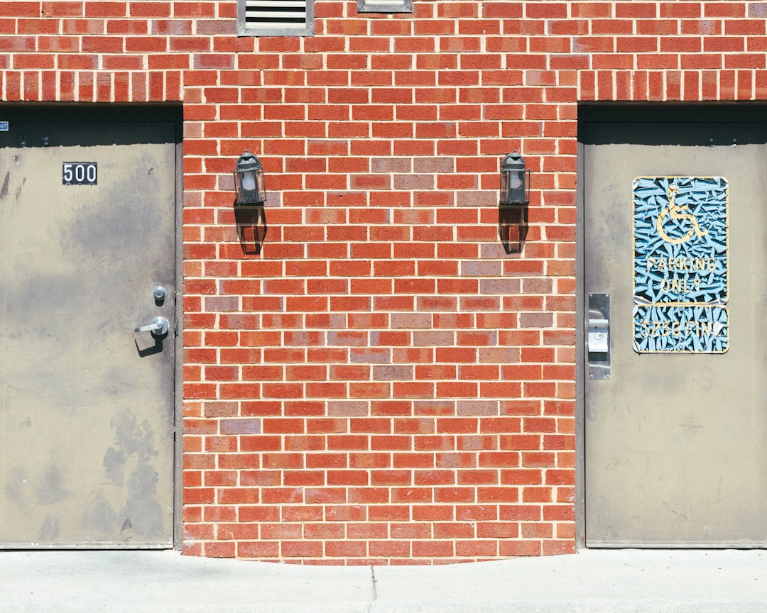 Doors on either side of a brick wall