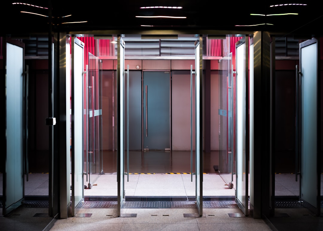 Glass revolving doors with modern interior lighting