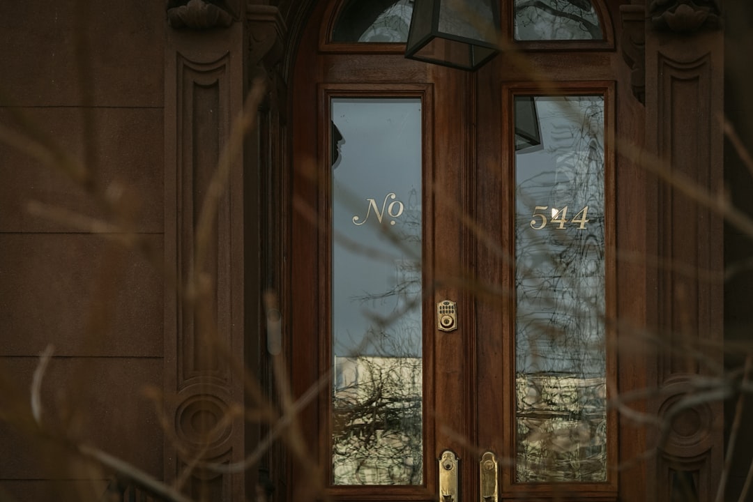 Wooden doors with glass panels and house numbers