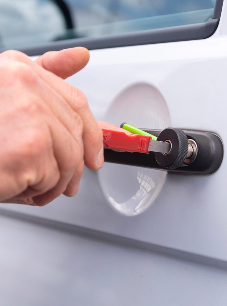 Locksmith opening a locked car door
